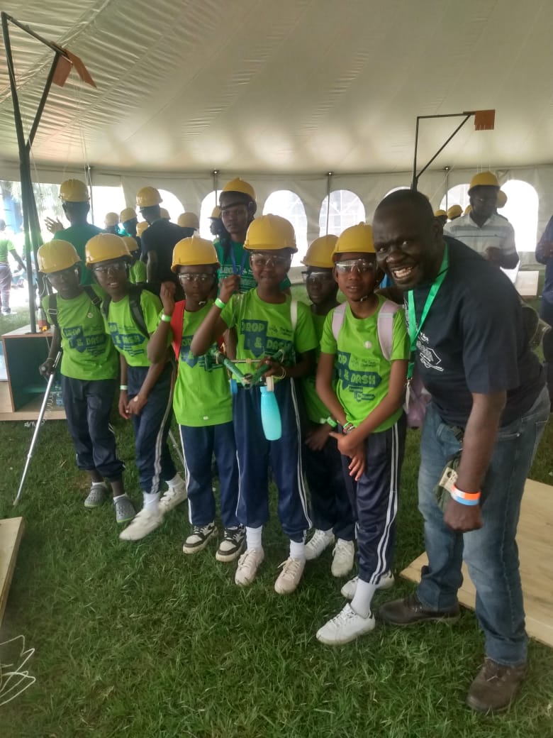 Students in Siaya, Kenya wearing hard hats and safety glasses at a STEM Sprouts activity